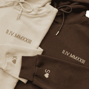 A close up of three different colored hoodies